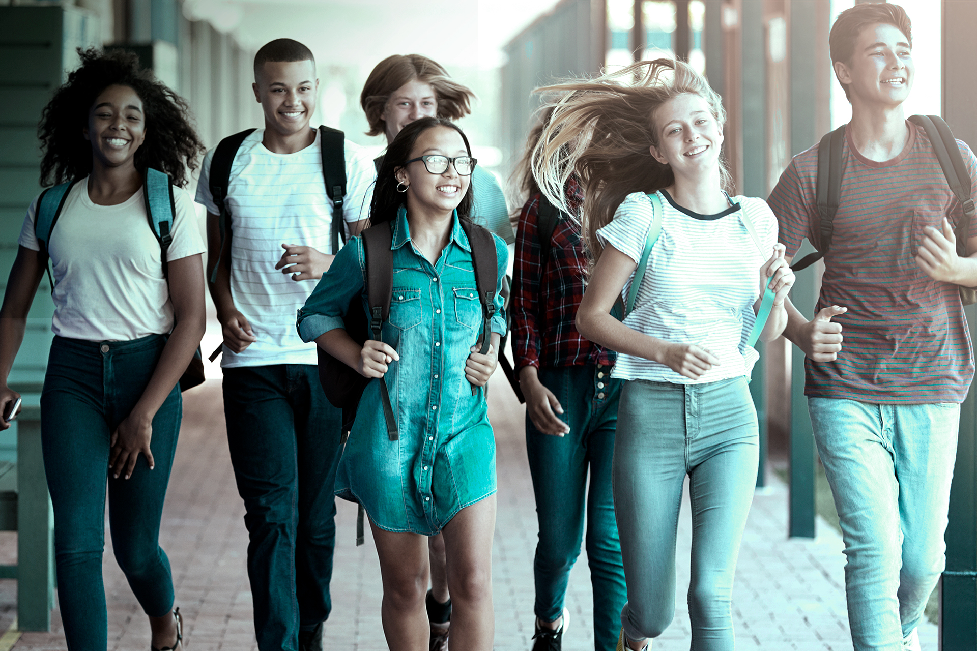 Teenager school kids running in high school hallway