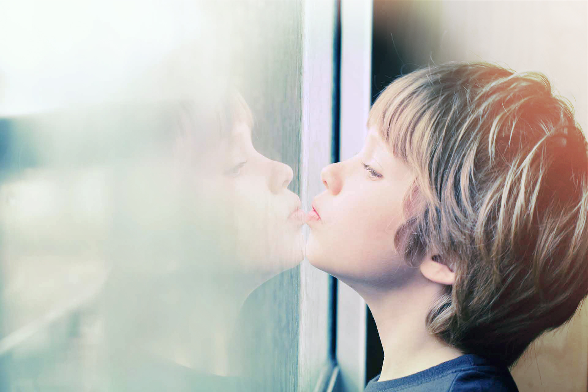 boy looking through the window